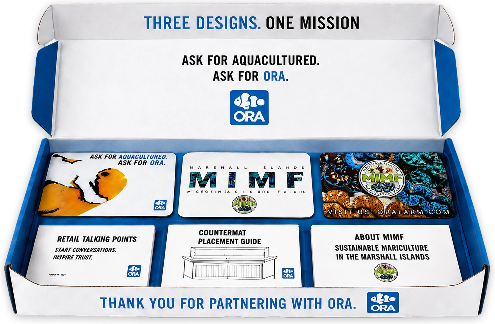 The open ORA welcome bundle box: the three countermats laid in the top tray and, below them, the retail talking points card, the countermat placement guide and an About MIMF card, under the line Three designs. One mission.