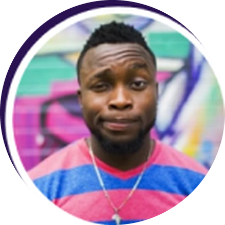 Xavier, in a striped shirt in front of a painted wall