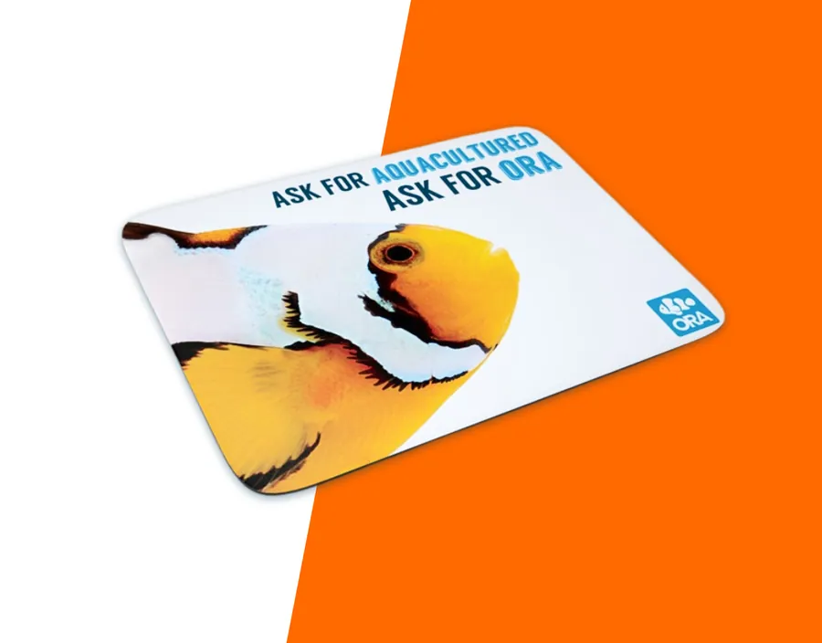 An ORA retail countermat printed with a clownfish and the line Ask For Aquacultured, Ask For ORA